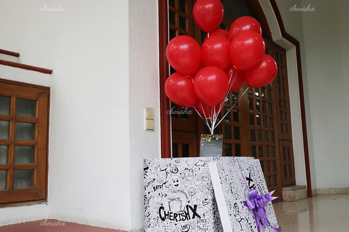 Bunch of Red balloons coming out of the surprise box.
