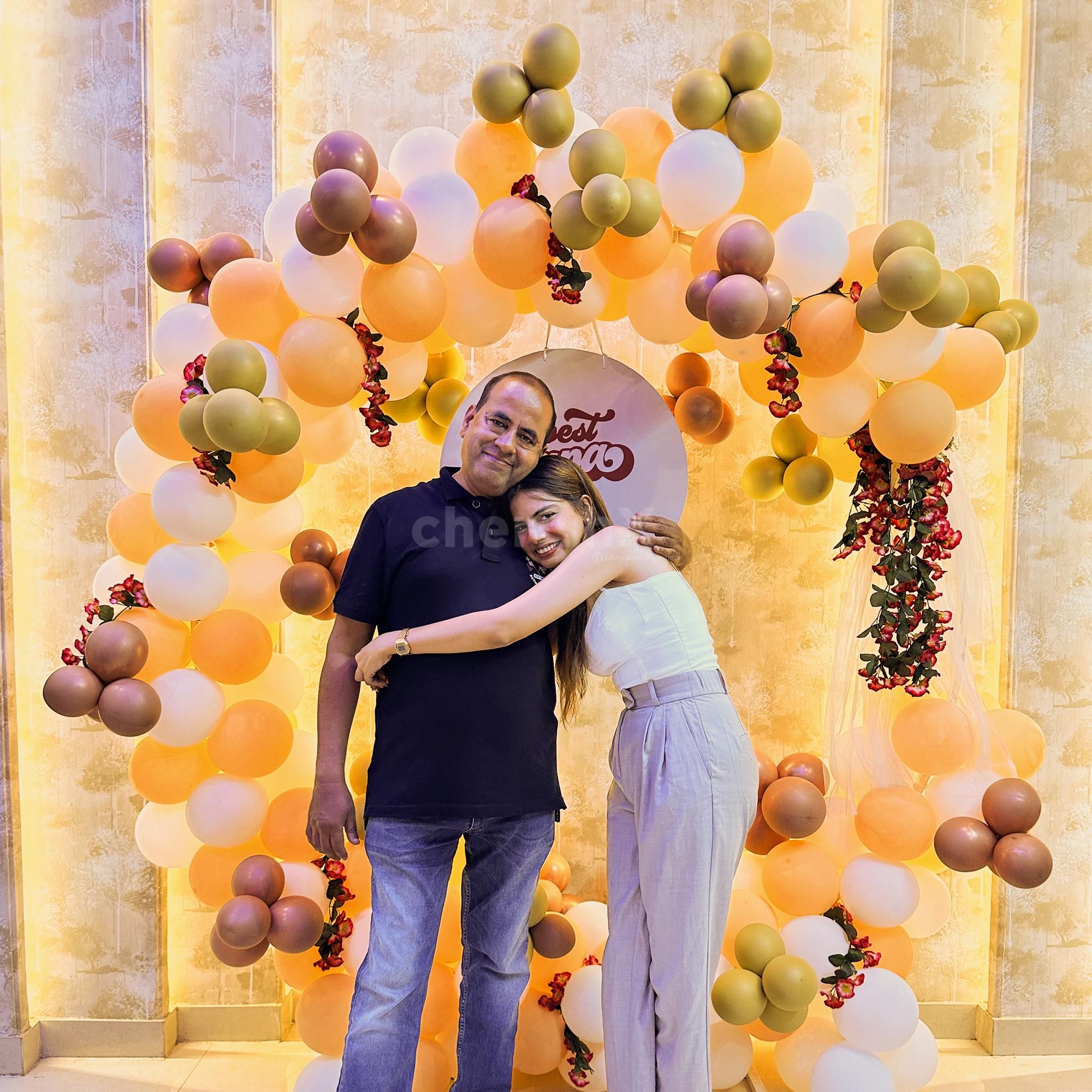 A spectacular array of Peach, Rose Gold, and white Macron Balloons elevates the ambience to new heights.