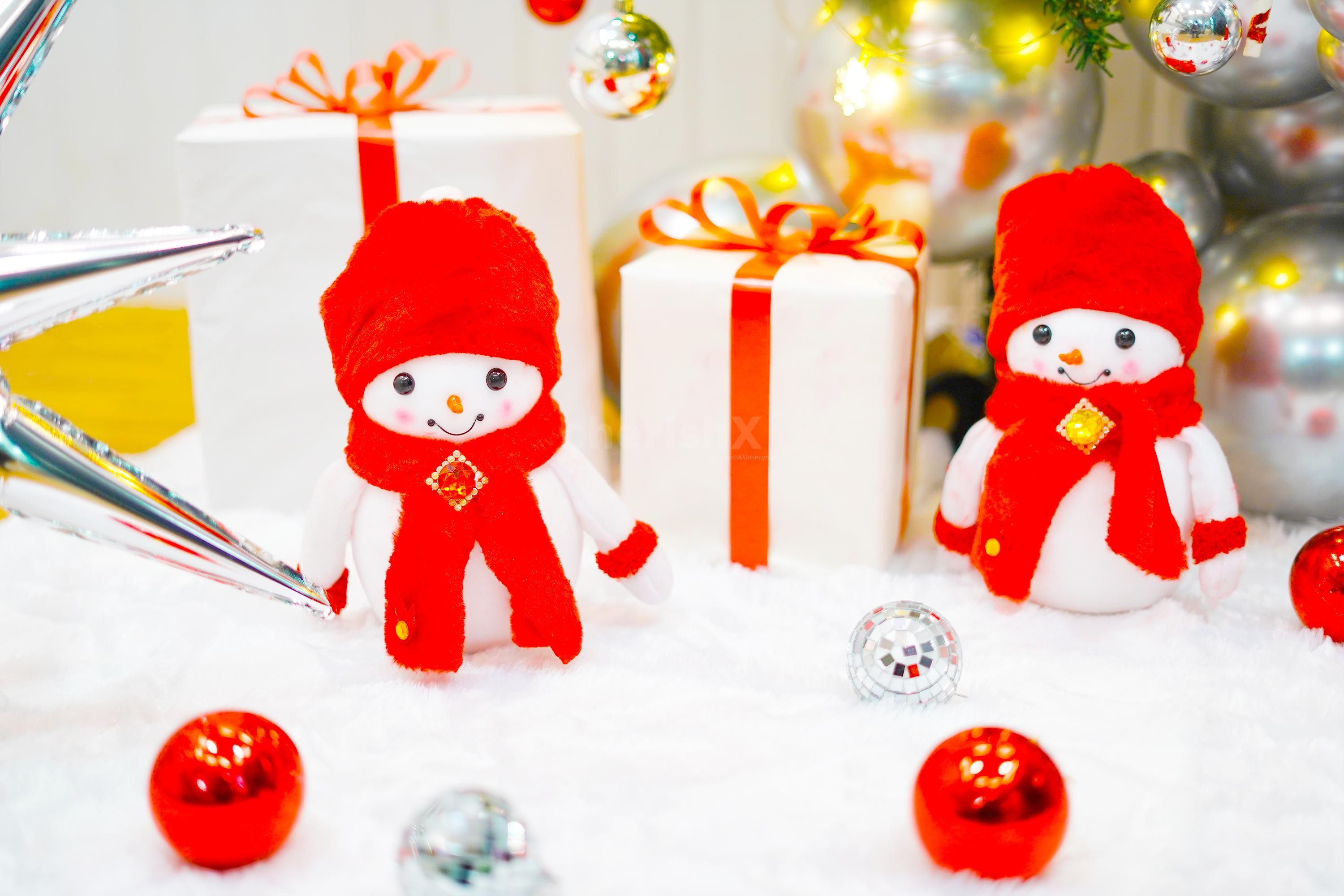 A Christmas tree also showcases beautifully arranged decorations, such as red Santa socks, and red deer ornaments.