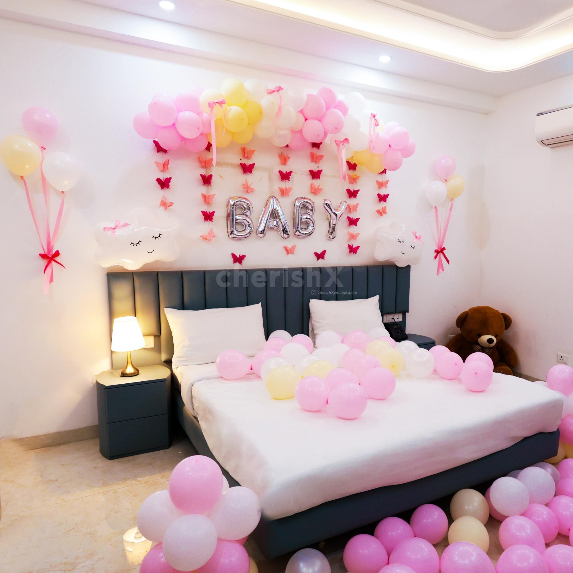 Pink butterflies and thematic ribbons add considerable depth to the wall design.