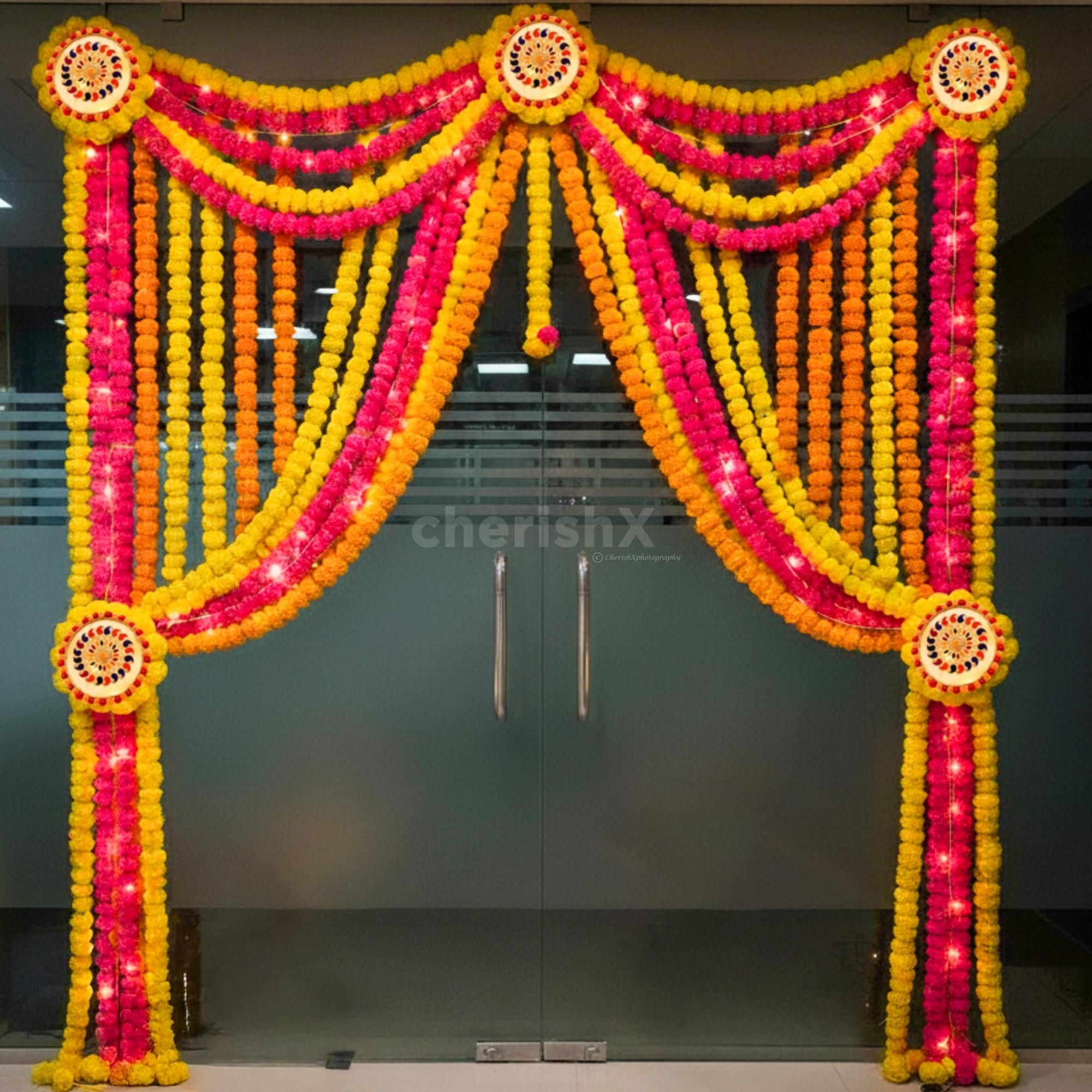 Floral drapes and lights highlight the golden and festive look of the entrance.