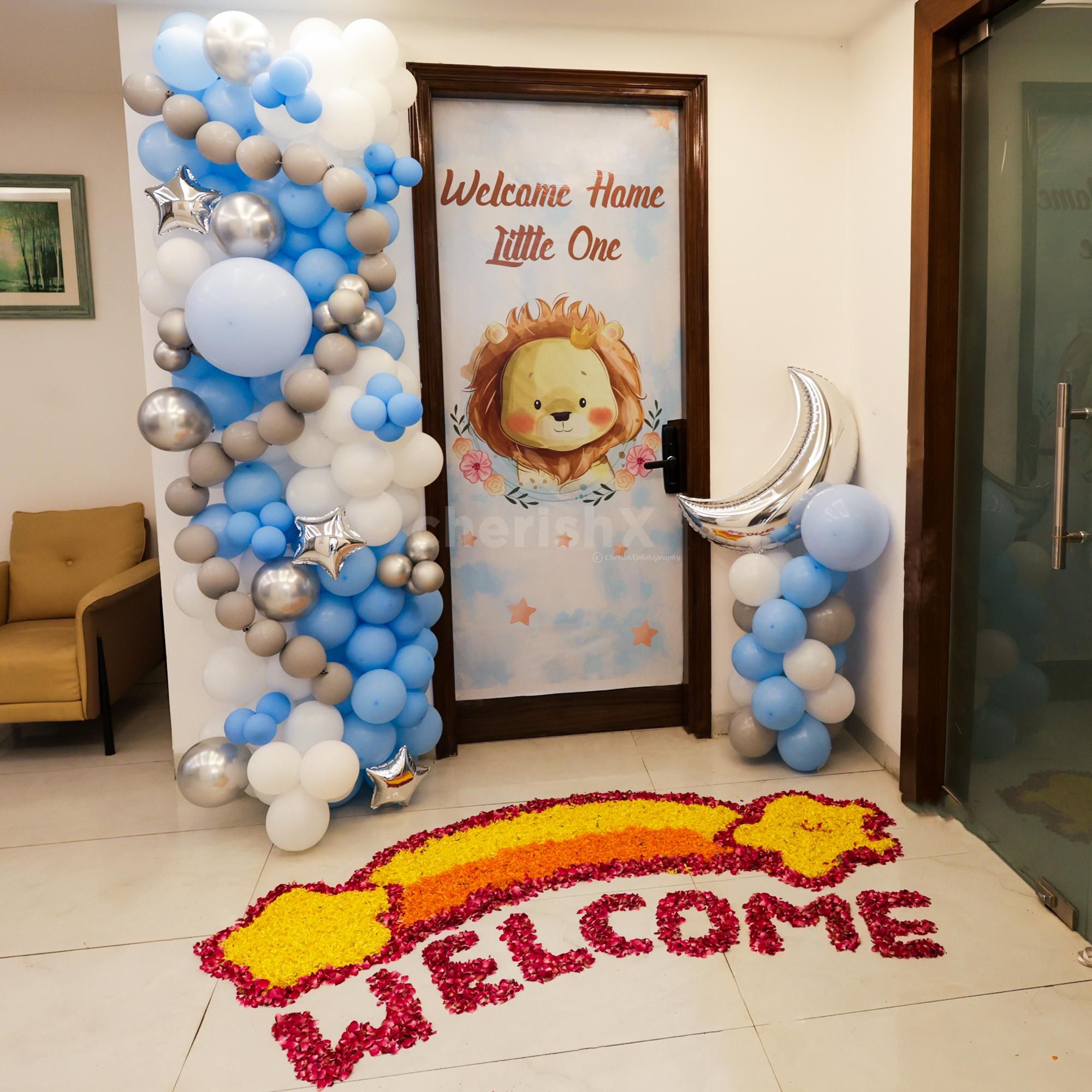 Dramatic pastel blue and white balloon arch for a beautiful greeting.