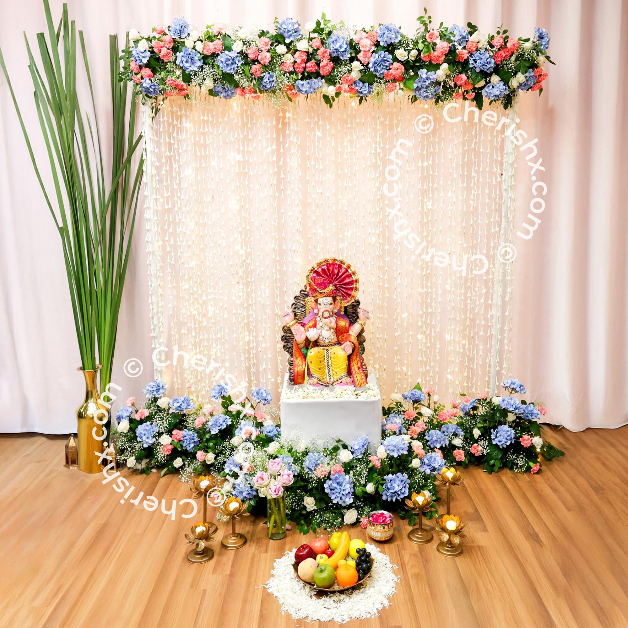Fresh white flower petals spread across the decor highlight purity of the puja