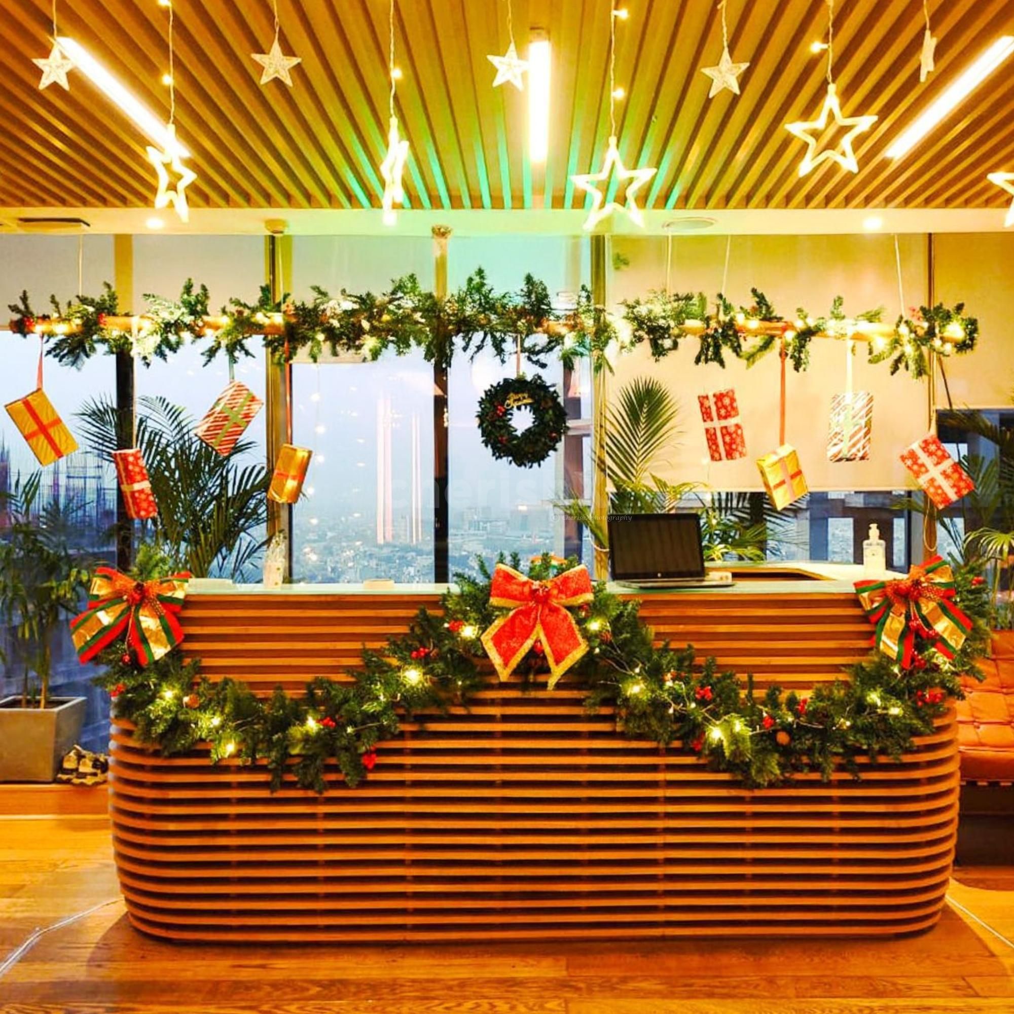 Wreath, gift boxes and star lights brighten up the office reception area for the celebration