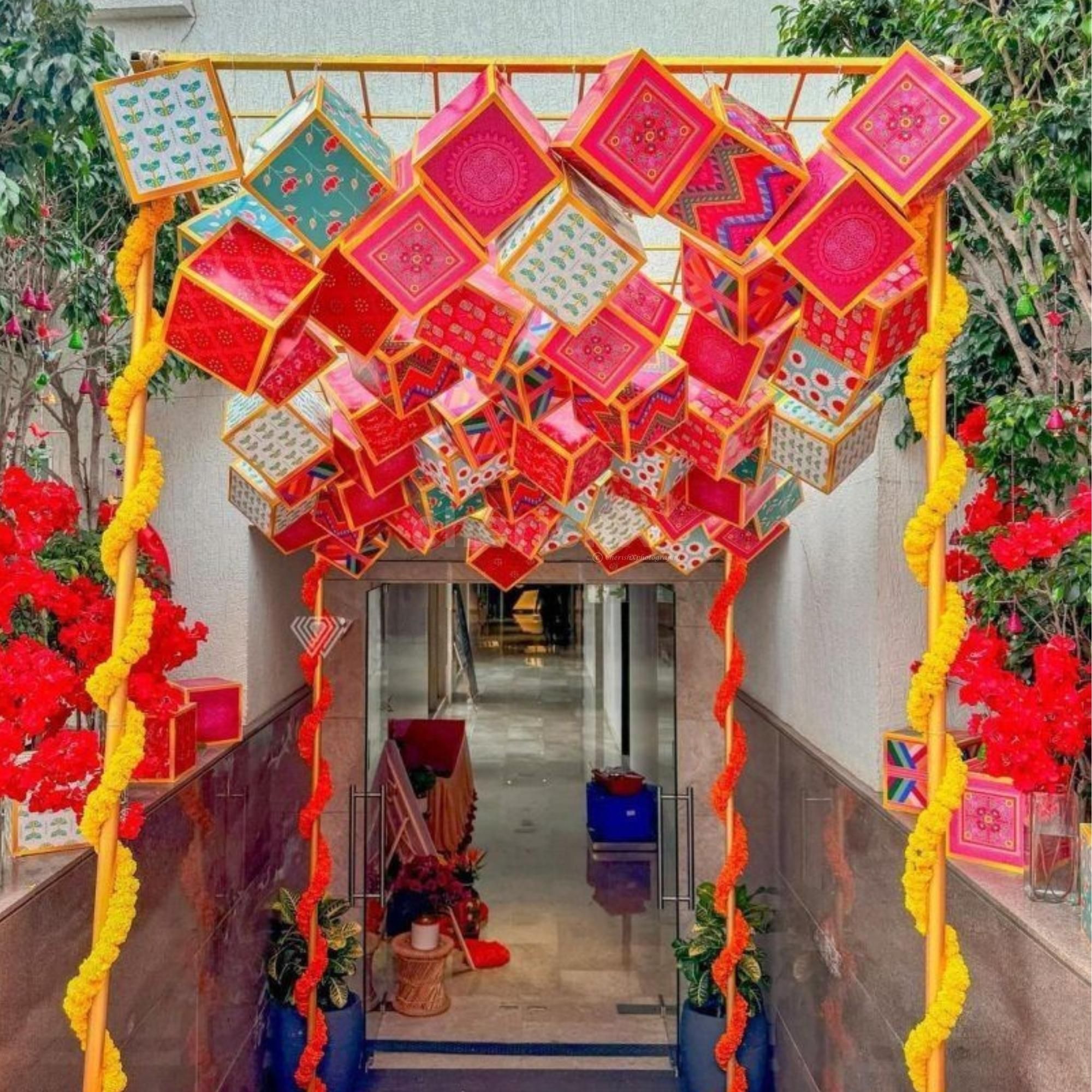 Floral strands add softness to the bold ceiling display.