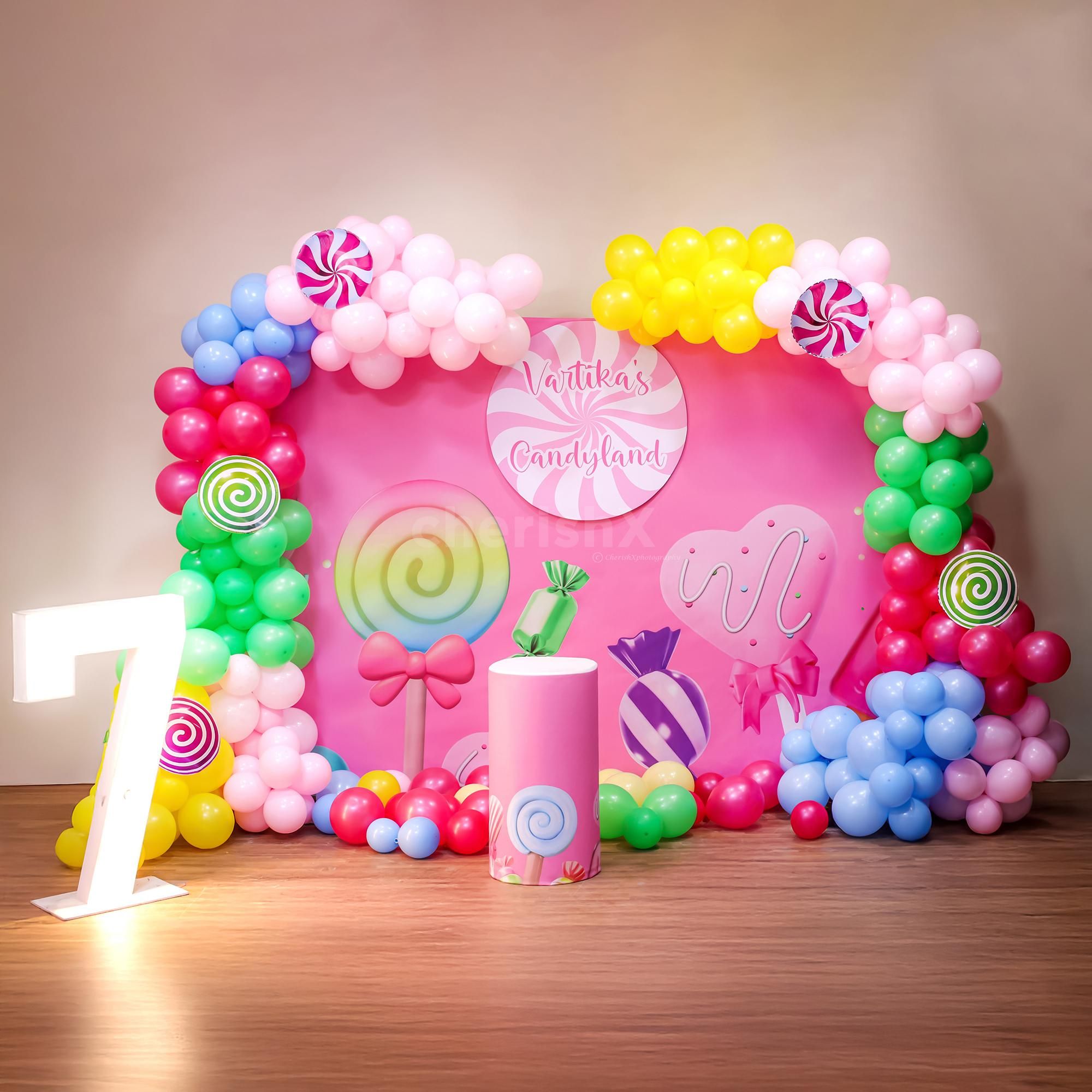 The balloon arch creates a mesmerising backdrop on the customised flex on the stand.