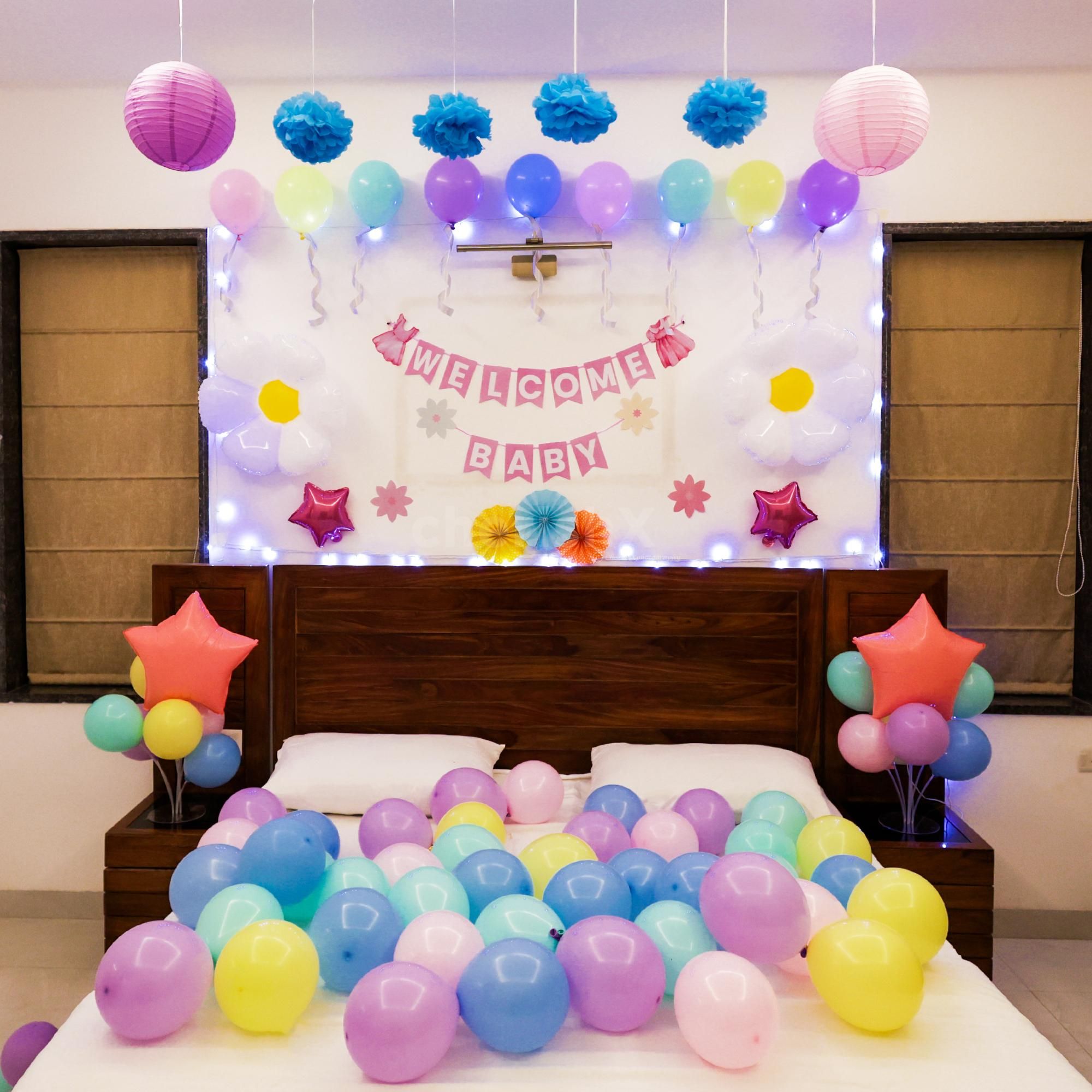 Fairy lights sparkle around a cozy "Welcome Baby" bunting.