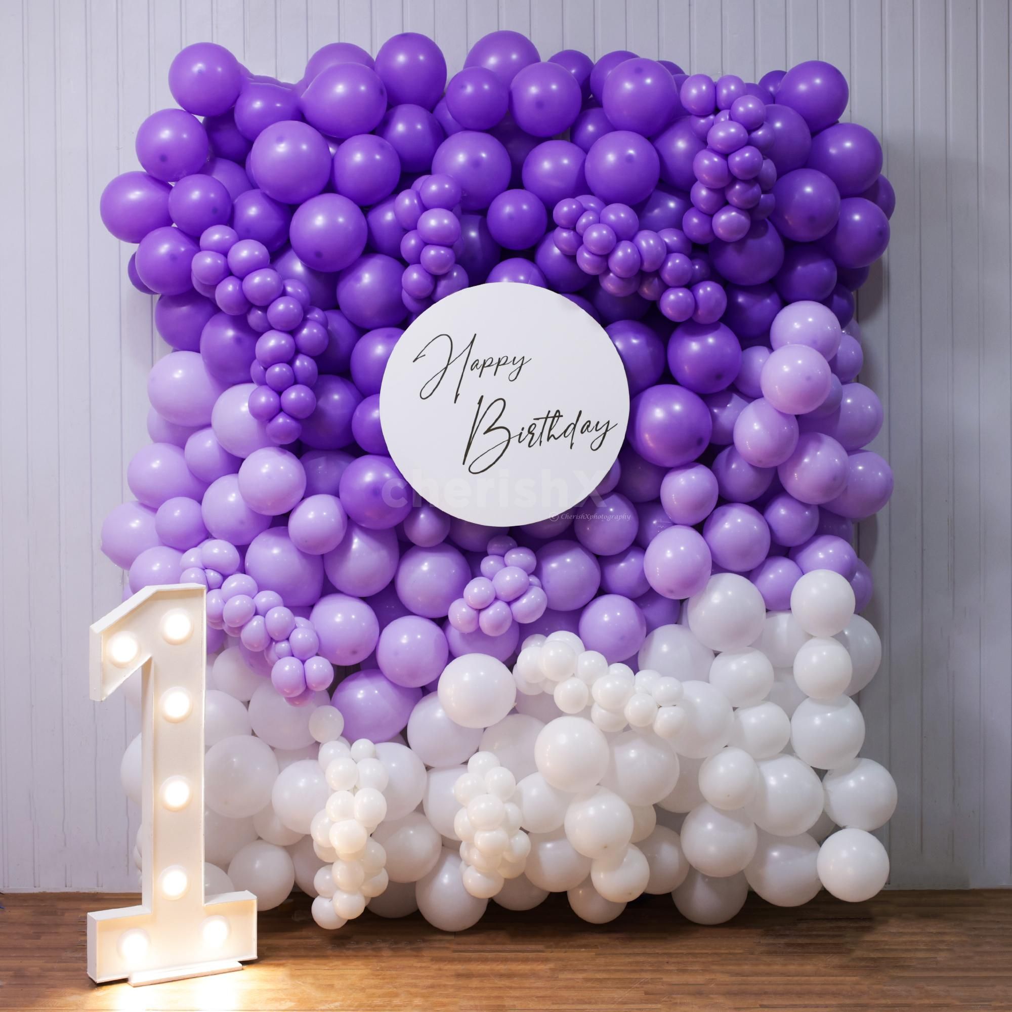 The purple balloon wall creates a wow-inspiring decor for unforgettable celebrations.