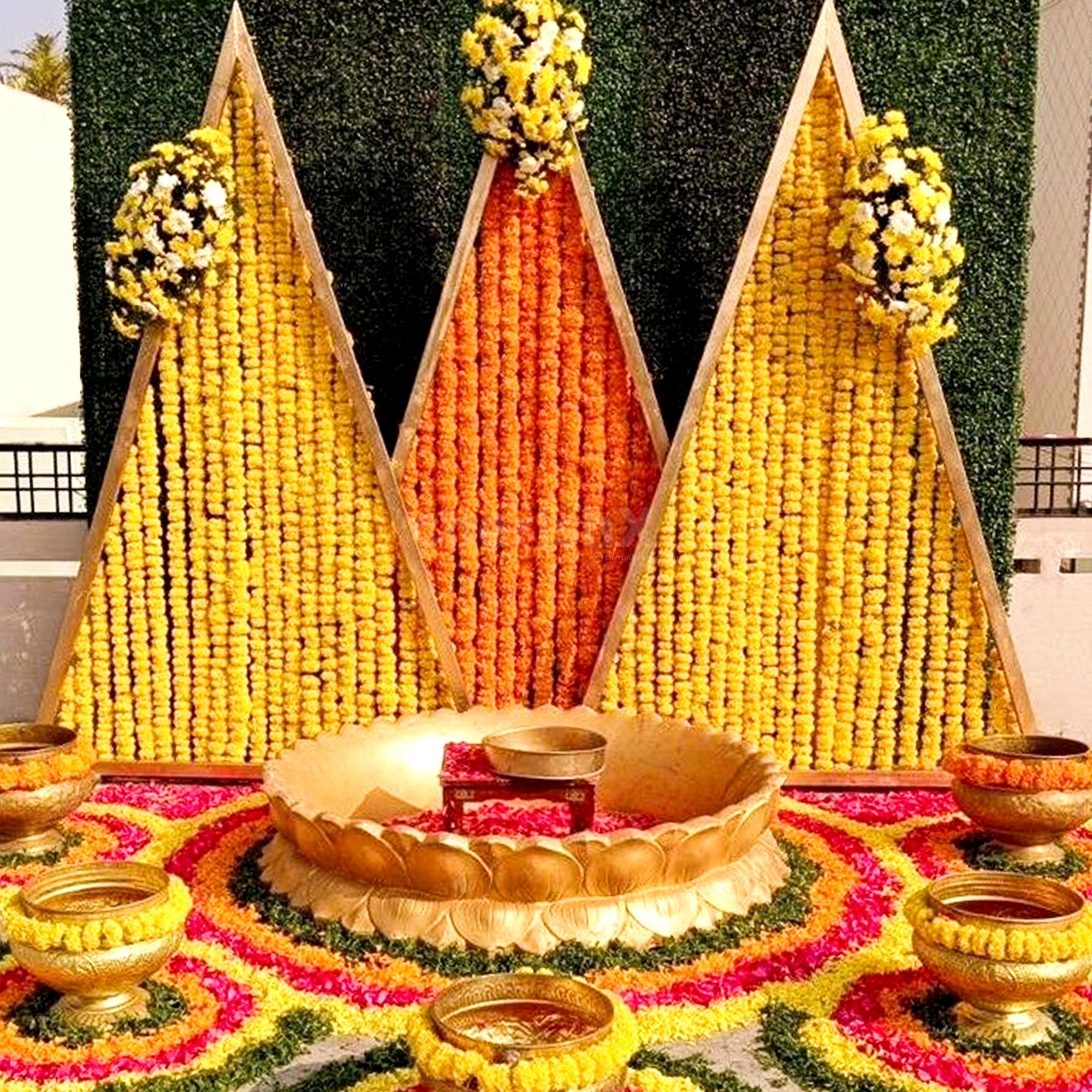 Marigold and lotus rangolis lend traditional warmth.