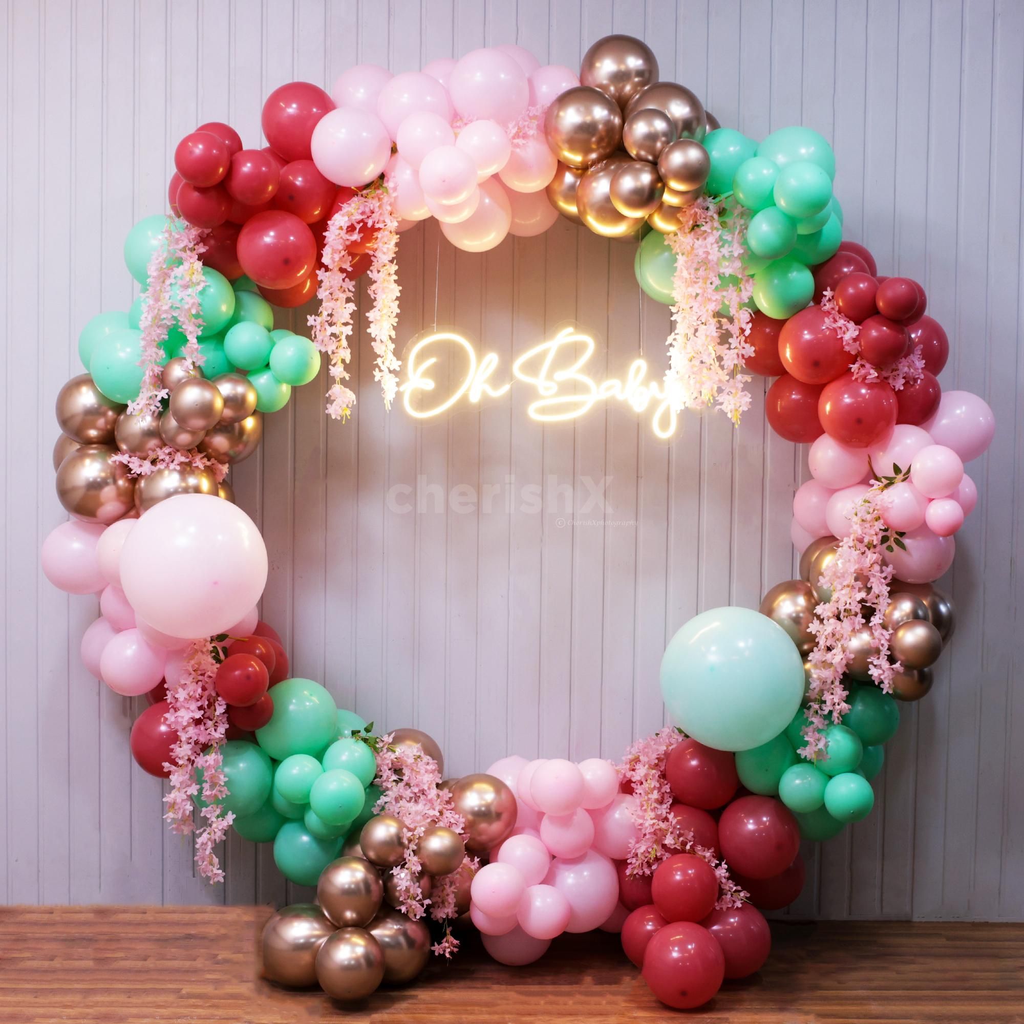 Cascading pink and pastel tones create a dreamy baby shower backdrop