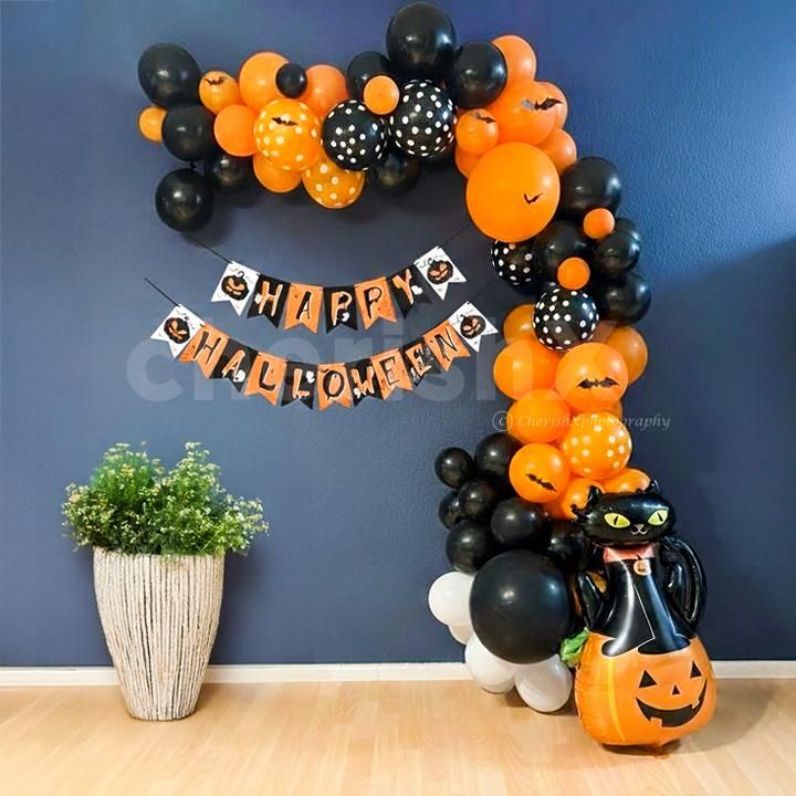 Multicolored balloons, bunting, and flying bat details celebrate Halloween spirit.