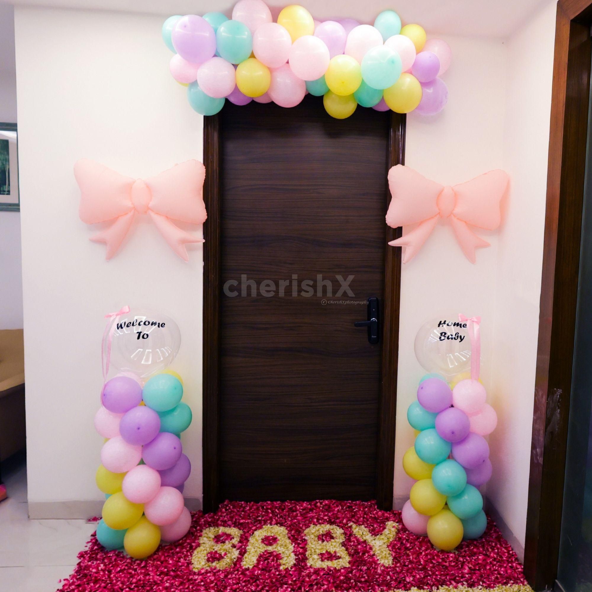 The pastel balloon arch lends a whimsical touch at the entrance.