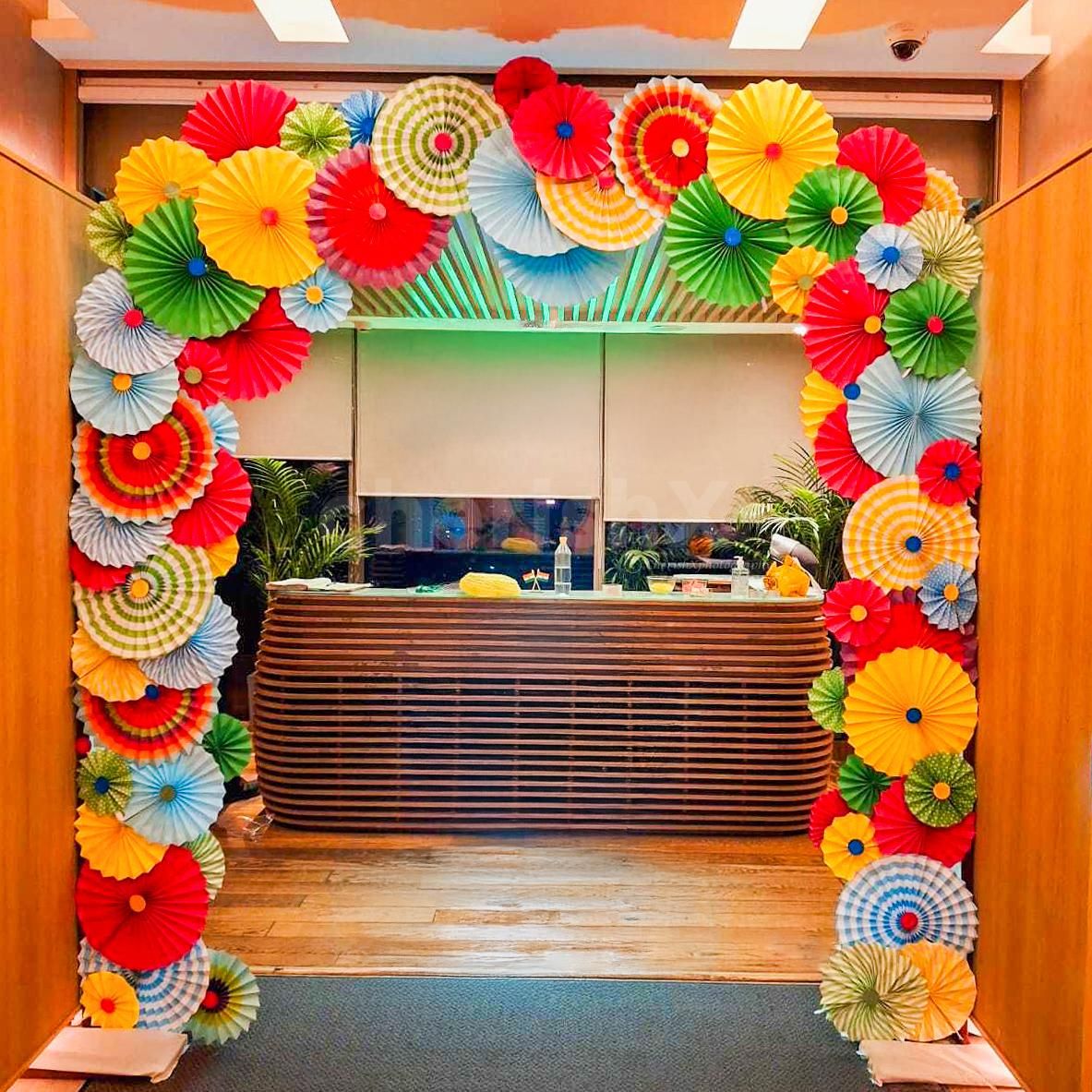 Layered multicoloured paper rosettes bring texture and life to the reception area