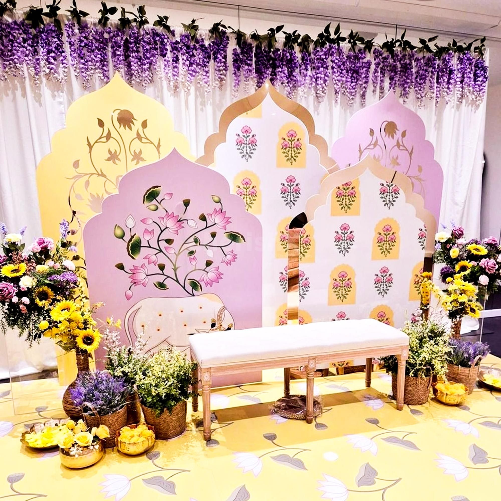 Royal pastel arch panels with floral paintings form a dreamy background.