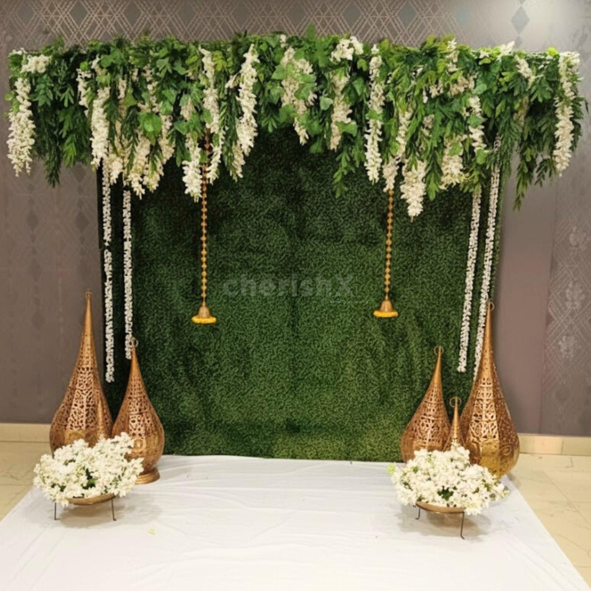 Wattle leaves add natural texture to the green wall decor, adding warmth